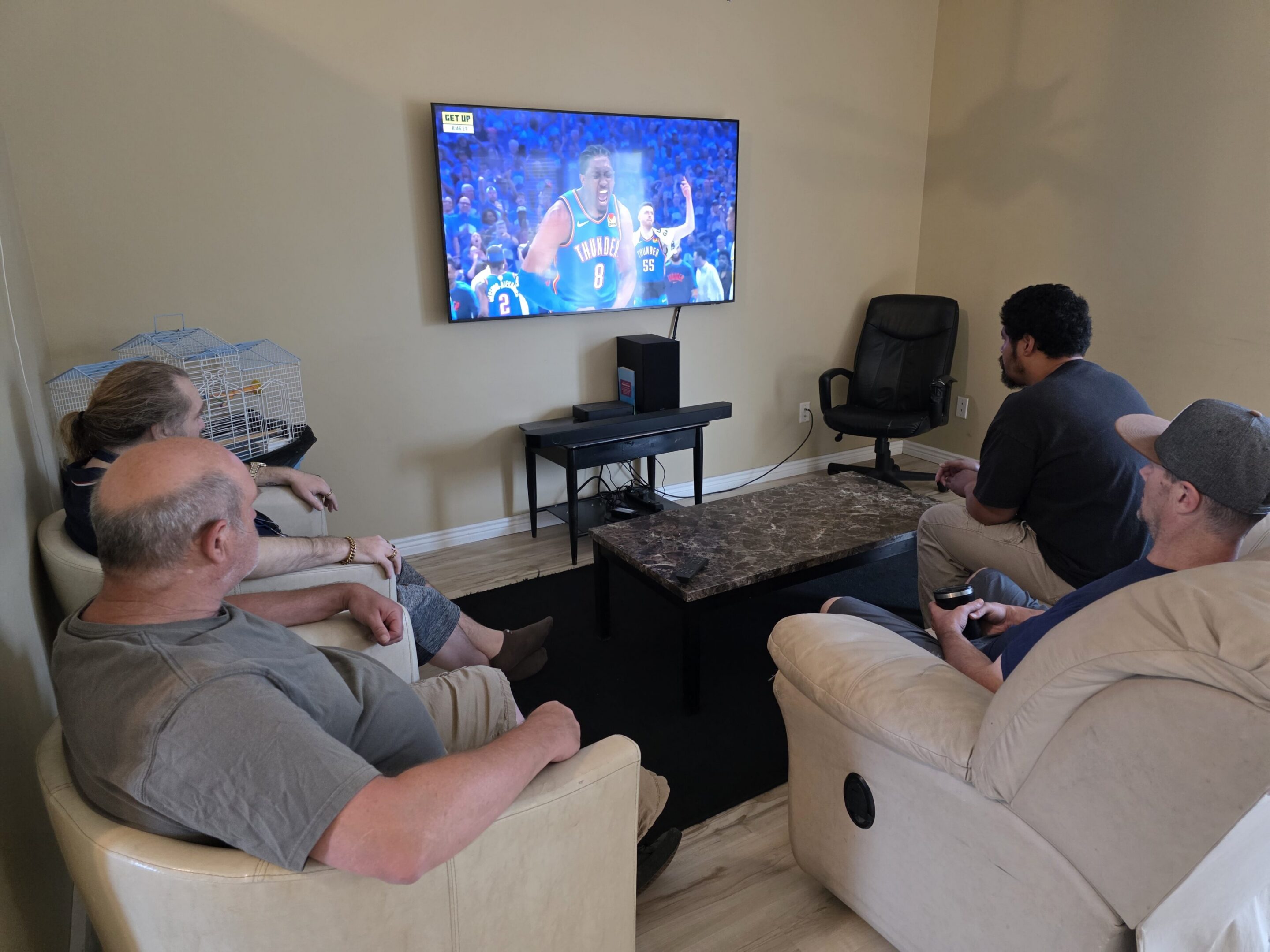 People watching basketball on wall-mounted TV