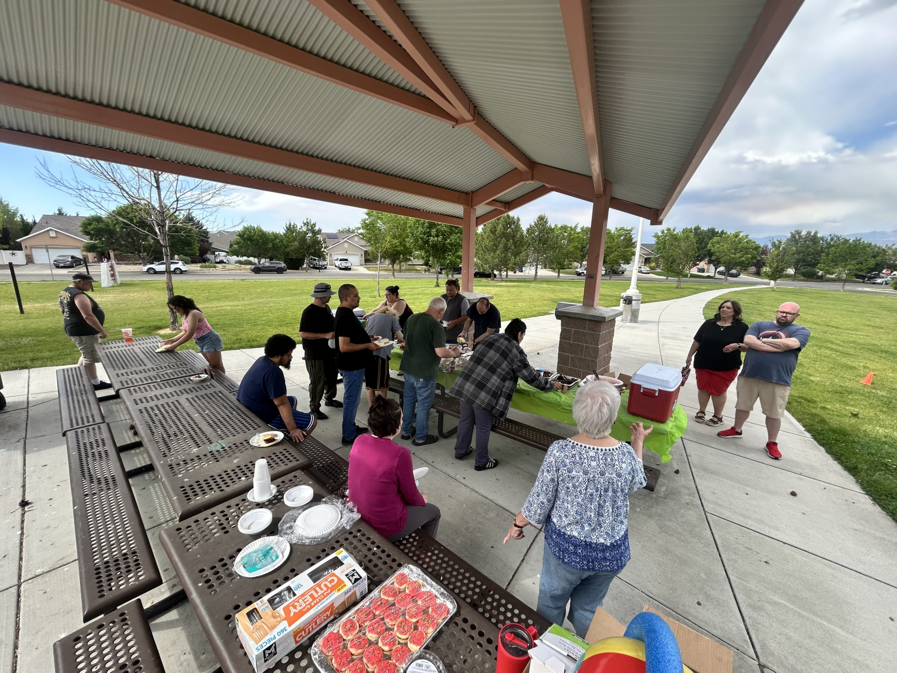 Community picnic under park pavilion with food