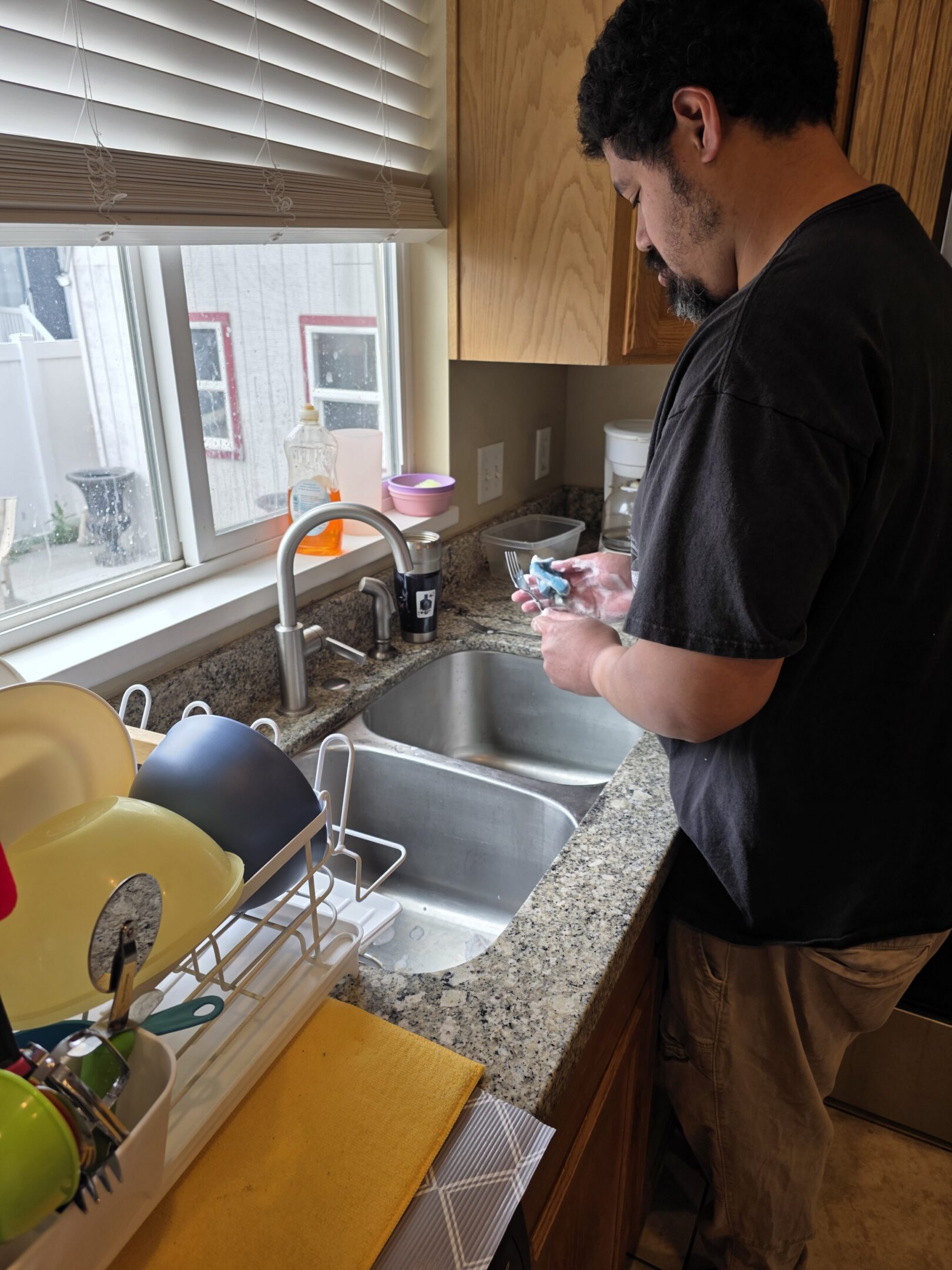 Person washing dishes at kitchen sink