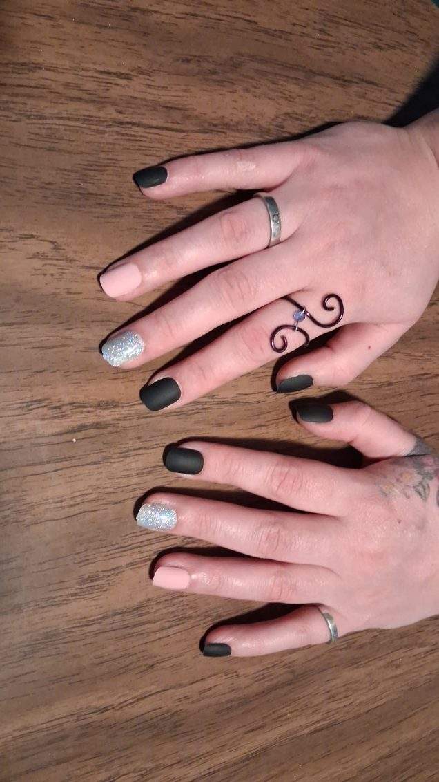 Hands with black matte and silver glitter nails